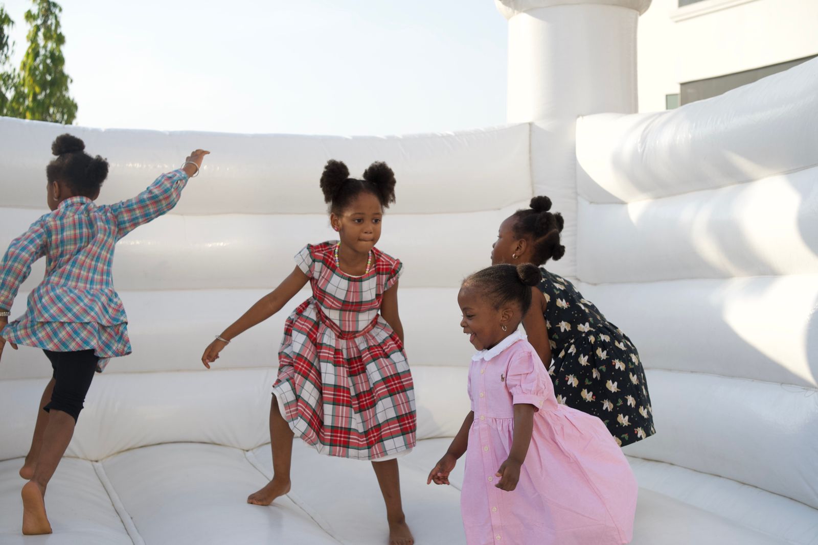 Children playing together on a white inflatable castle