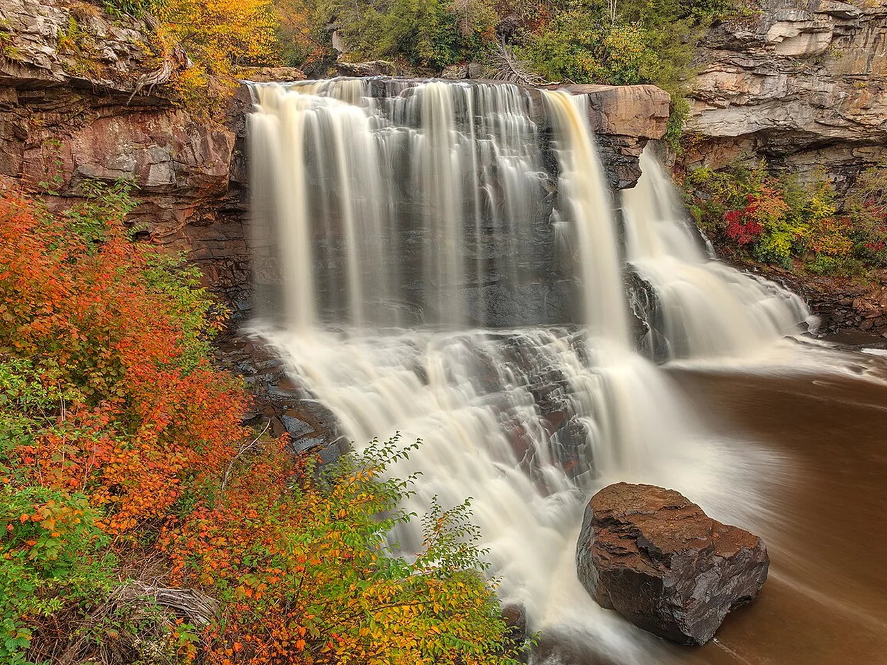 Blackwater Falls framed by orange and gold leaves