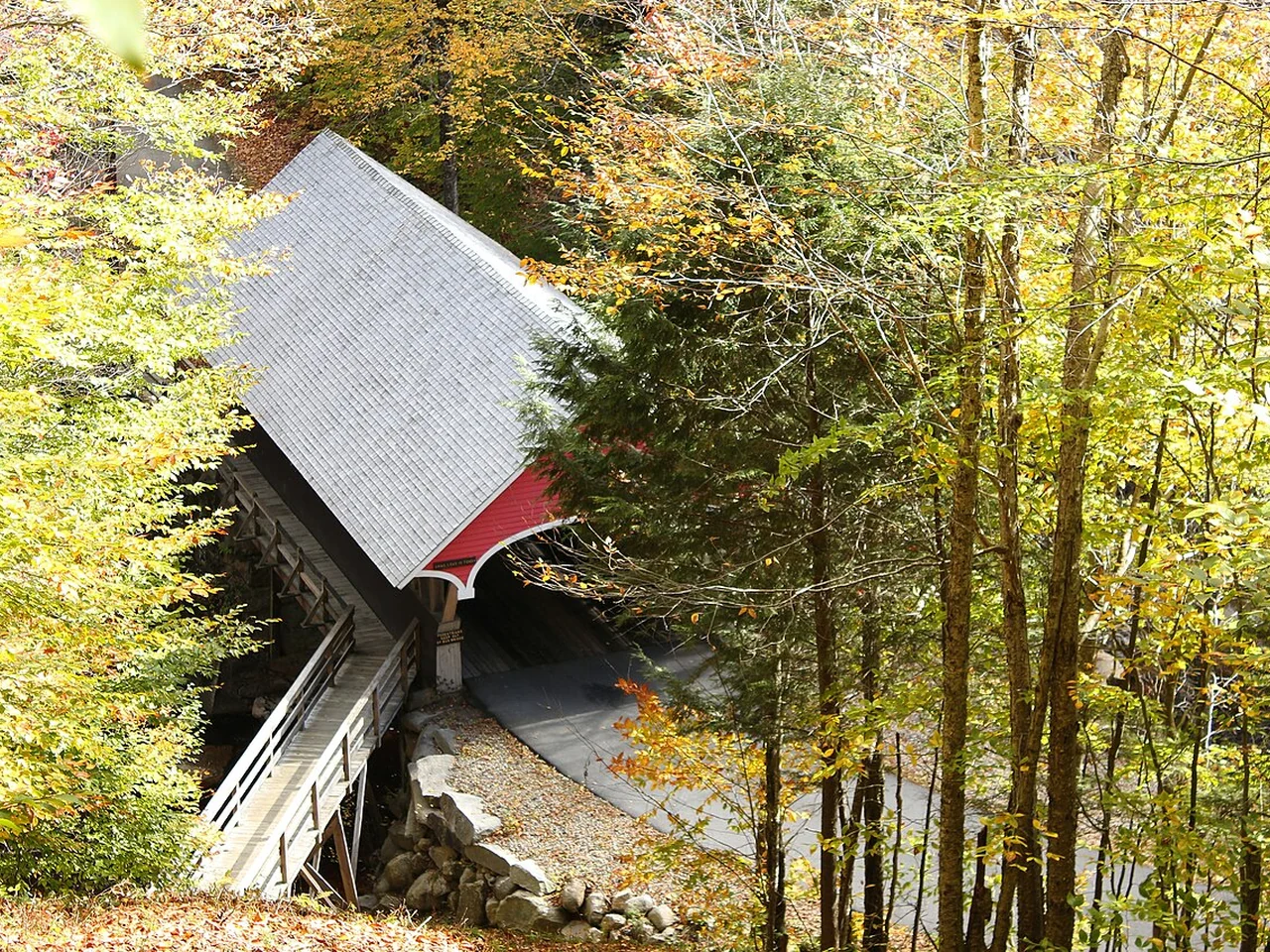 Covered bridge and early autumn trees at Flume Gorge