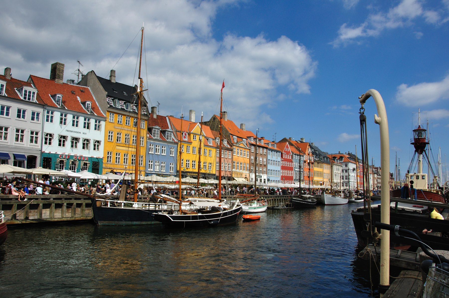 Colorful waterfront houses and moored boats along Nyhavn in Copenhagen, Denmark