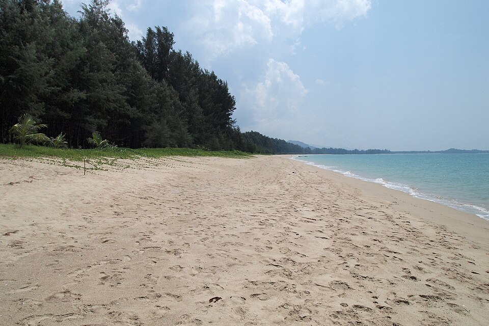 Sandy beach meeting pale turquoise Andaman Sea water at Khao Lak, Thailand