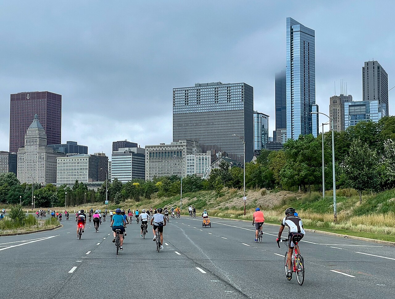 Cyclists riding along car-free Lake Shore Drive beneath the Chicago skyline